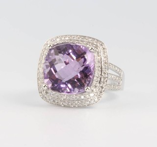 A 14ct white gold cushion cut amethyst ring approx. 8.37ct, surrounded by brilliant cut diamonds approx. 0.6ct, size M 1/2