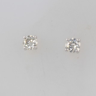 A pair of 18ct white gold single stone diamond ear studs approx. 0.57ct 