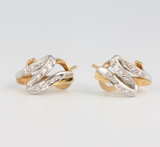 A pair of 18ct white and yellow gold diamond ear clips, 5.1 grams