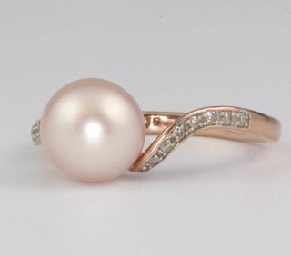 A 9ct rose gold pearl and diamond crossover ring, size L, 2.2 grams 