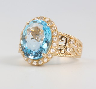 A 14ct yellow gold oval cut topaz and diamond ring, the centre stone approx. 5.92ct surrounded by brilliant cut diamonds approx. 0.35ct size N 1/2 