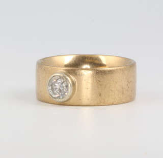 A 9ct yellow gold broad band ring set with a brilliant cut diamond approx. 0.7ct, 10 grams 