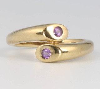 A 9ct yellow gold amethyst set cross-over ring, size P, 4 grams