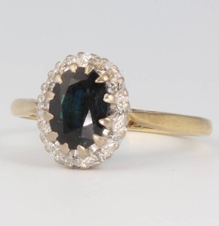 An 18ct yellow gold oval sapphire and diamond cluster ring size O, 3 grams 