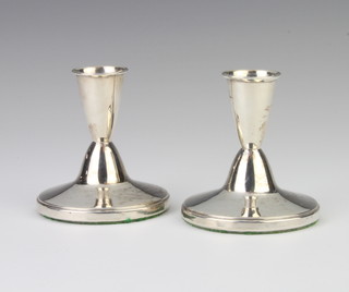A pair of silver dwarf candlesticks 7cm h (marks rubbed)