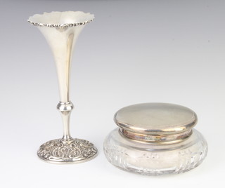 A silver engine turned lidded cut glass powder jar, Birmingham 1963, a tapered silver posy vase with repousse decoration, rubbed marks 139 grams 