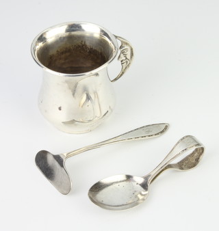 A silver mug with moon handle, Birmingham 1956, a pusher and spoon 88 grams
