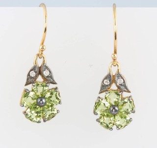 A pair of silver gilt peridot and diamond floral earrings
