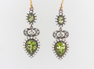 A pair of silver gilt Edwardian style pear cut peridot, seed pearl and diamond earrings