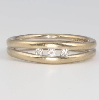 An 18ct yellow gold channel set 3 stone diamond ring, size M, 5.3 grams