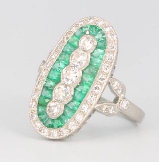 A platinum Art Deco style 5 stone diamond and emerald oval ring, size  N