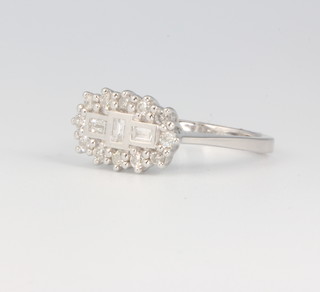 An 18ct white gold baguette and brilliant cut ring approx. 0.5ct, size O