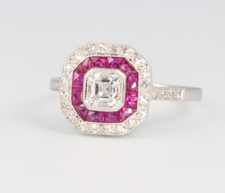 An 18ct white gold Art Deco style diamond and ruby ring, the centre diamond approx. 0.75ct set in an octagonal mount flanked by rubies and diamonds, size N 1/2