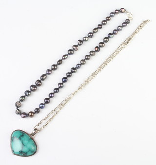 A silver necklace and pendant and a bead necklace 
