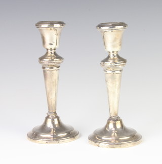 A pair of Georgian style tapered silver candlesticks, London 1959 17cm