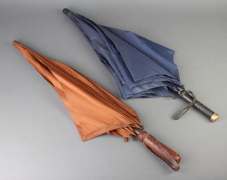A blue parasol with snakeskin grip and a 9ct yellow gold terminal by Biggs of London and a brown ditto (no gold terminal)