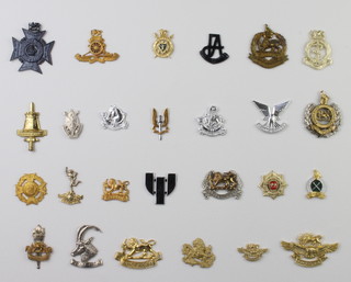 A collection of 26 Rhodesian Army cap badges together with a limited edition volume David Laird "Uniforms of the Security Forces of Rhodesia" no 400 of 515 