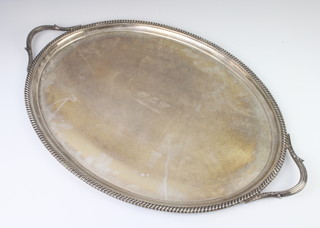 An oval silver 2 handled tray with gadrooned rim, London 1922, 2562 grams, 60cm 