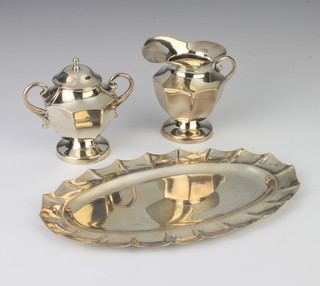 A sterling silver oval shaped tray, cream jug and lidded sugar bowl 600 grams 