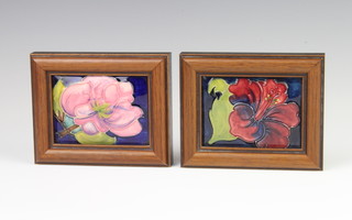Two Moorcroft box lids decorated with flowers, framed 12cm x 10cm 