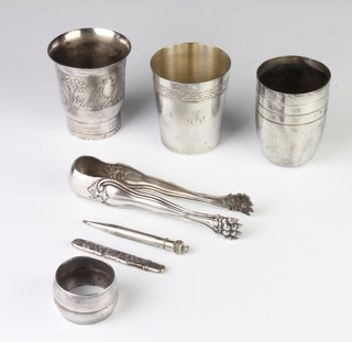 A pair of Sterling silver sugar tongs, 3 beakers and minor items 