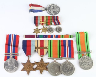 A World War Two medal group comprising 1939-45 and Africa Star with North Africa 1942-43 bar, Defence War medal together with miniatures and minor medals 