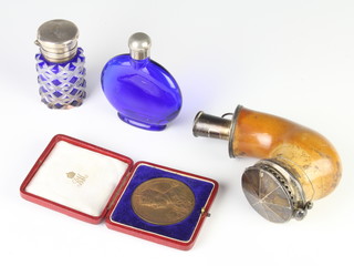 An overlaid cut glass toilet bottle with silver lid, a pipe, medallion and flask 