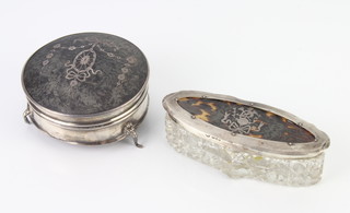 A circular silver and tortoiseshell trinket box Birmingham 1918 8 1/2cm, an oval ditto with cut glass base London 1912 