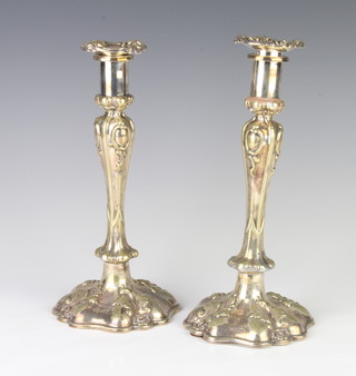 A pair of silver plated tapered candlesticks with scroll decoration 24cm 