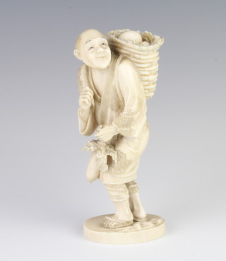A Meiji period Japanese ivory figure of a street seller holding a basket of fruit on his back, signed 16cm 