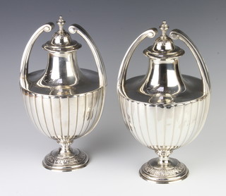 A pair of impressive repousse silver 2 handled classical urn shaped cups and covers with presentation inscription C.Collaro M.I.G.S Senior Aggregate Cup, London 1926, maker Sebastian Henry Garrard, 29cm, 2394 grams 