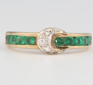 A 9ct yellow gold emerald and diamond buckle ring, size K 1/2, 2.2 grams