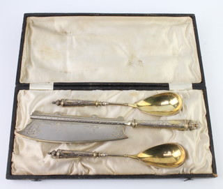 A 19th Century Continental 800 standard serving set comprising knife and 2 gilt decorated spoons, cased
