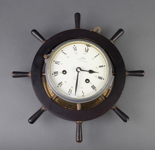 Schatz Royal Marine, a striking ward room clock, the 15cm painted dial with Arabic numerals and 24 hour numerals contained in a wooden wheel shaped case  
