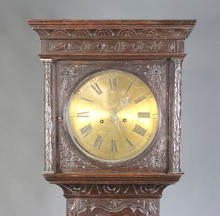 Broadhurst, a 19th Century 8 day striking longcase clock, the 30cm circular brass dial with Roman numerals contained in a heavily carved oak case, the door carved a figure of a standing knight, complete with pendulum and weights 211cm h  