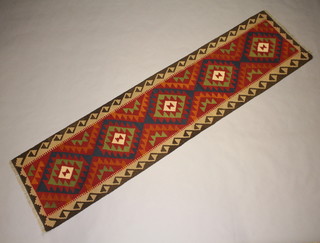 A green, blue and red Maimana Kilim runner with stylised diamonds to the centre 310cm x 78cm  
