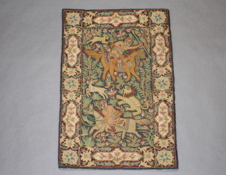 A Kashmiri hand stitched pictorial wool panel decorated a figure of a huntsman 86cm x 57cm 