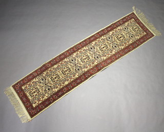 A white and floral ground Tunisian runner within a 3 row border 284cm x 73cm 