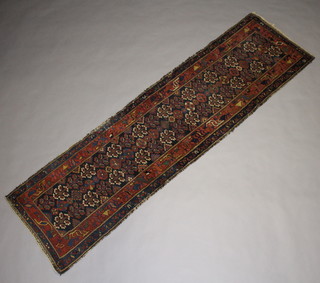 A blue and red Persian floral patterned runner within a multi row border 295cm x 80cm  