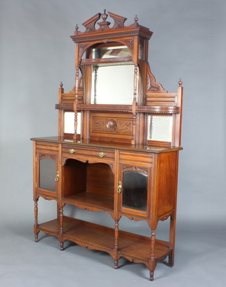 An Edwardian carved walnut chiffonier, the raised mirrored back with broken pediment, fitted shelves and triple plate mirrors, the base fitted a drawer above a recess flanked by a pair of cupboards enclosed by glazed panelled doors, raised on turned and block supports 215cm h x 126cm w x 39cm d 