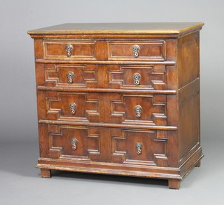 A 17th Century style oak chest of 4 long drawers with geometric mouldings and pierced drop handles, raised on square supports 81cm h x 83cm w x 48cm d 