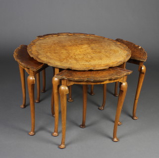 A Queen Anne style circular figured walnut nest of four interfitting coffee tables with quarter veneered and pie crust top, raised on cabriole supports 51cm h x 72cm diam. 