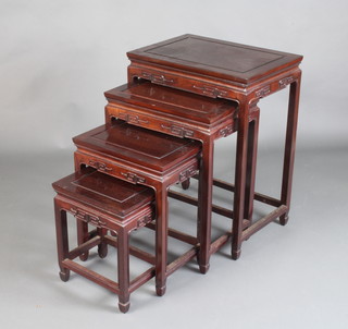 A nest of 4 Chinese Padauk interfitting coffee tables with carved apron, 67cm h x 51cm w x 36cm d, 56cm h x 44cm w x 30cm d, 46cm h x 37cm d x 26cm d and 36cm h x 30cm w x 22cm d 
