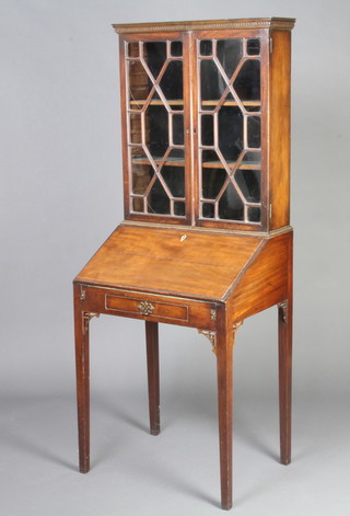 A Georgian mahogany bureau bookcase, the upper section with moulded and dentil cornice fitted shelves enclosed by astragal glazed panelled doors, the fall front revealing a well fitted interior, the base fitted 1 long drawer, raised on square tapered supports 164cm h x 75cm w x 47cm d 