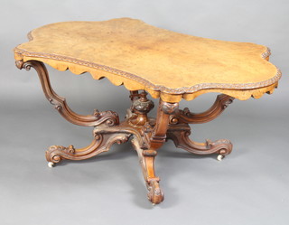 A Victorian figured walnut centre table with quarter veneered top raised on a carved column base with carved lidded urn to the centre 69cm h x 153cm w x 101cm d 