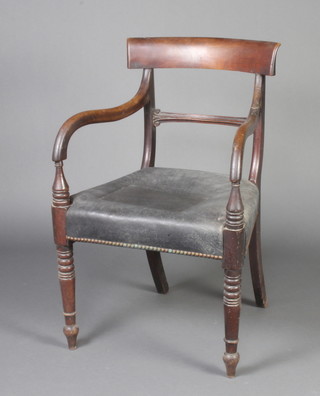 A 19th Century mahogany bar back desk/carver chair with carved mid rail and over stuffed seat, raised on turned supports 