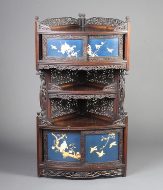 A 19th Century Japanese carved hardwood Fujiyama corner cabinet, the upper section with cupboard enclosed by sliding doors above a recess, the base enclosed by sliding doors inlaid ivory panels of birds 114cm h x 63cm w  39cm d  