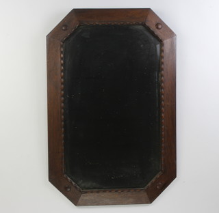 A 1920's octagonal bevelled plate wall mirror contained in an oak frame 75cm x 50cm 