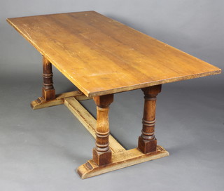A 19th Century rectangular pine refectory dining table raised on 4 columns with H framed stretcher 76cm h x 183cm l x 86cm w 