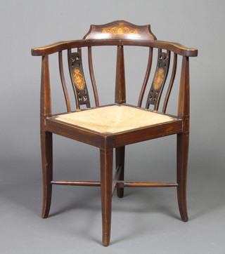An Edwardian inlaid mahogany corner chair with woven rush seat, raised on outswept supports with  X framed stretcher 